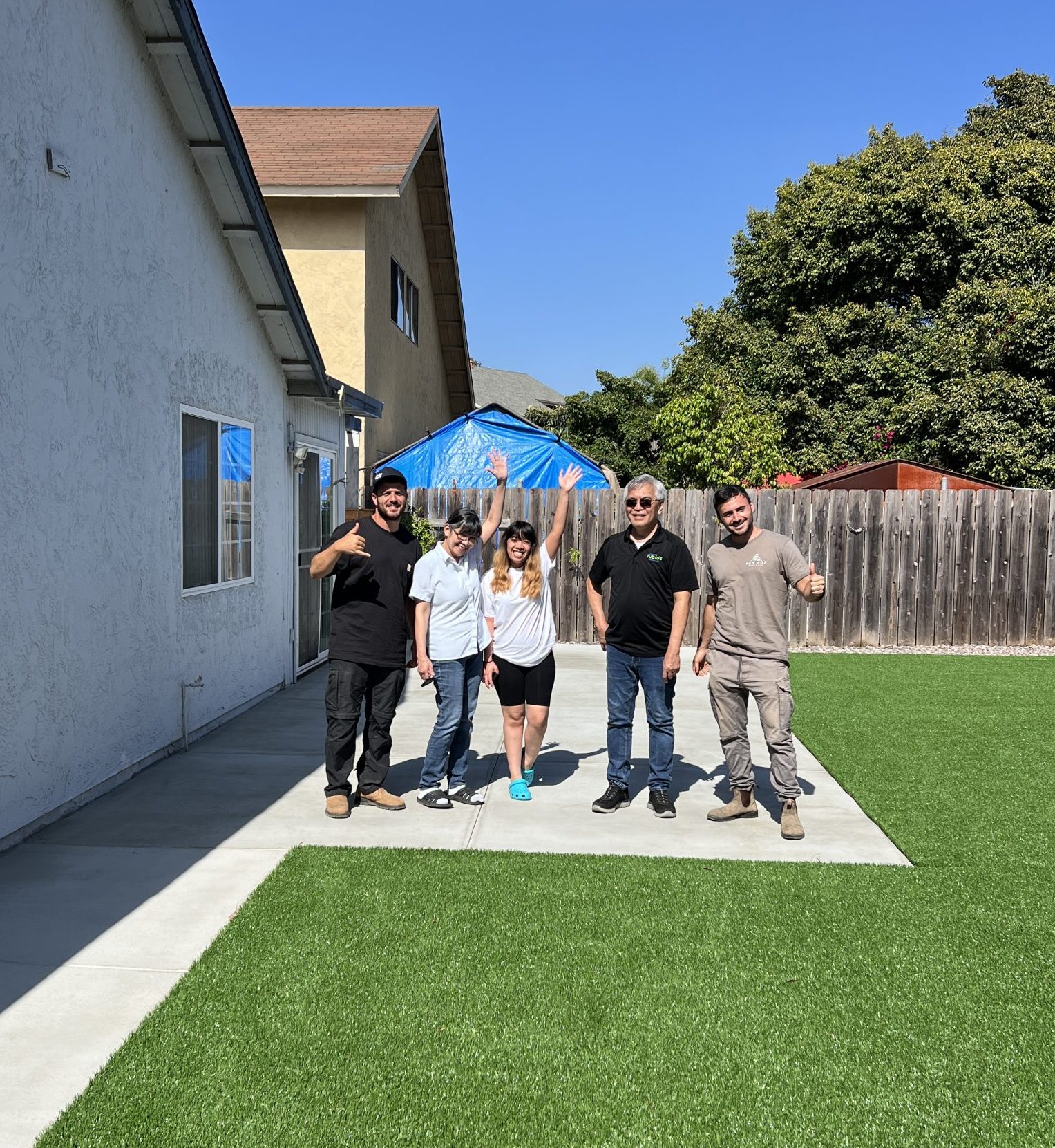 our team with happy customer after back and front yard renovation project